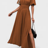 Eterna | Elegantna dugačka haljina u crnoj boji s V izrezom, prozirnim rukavima i otvaranjem